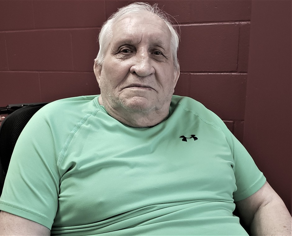 Portrait image of elderly man in neon green sports t-shirt